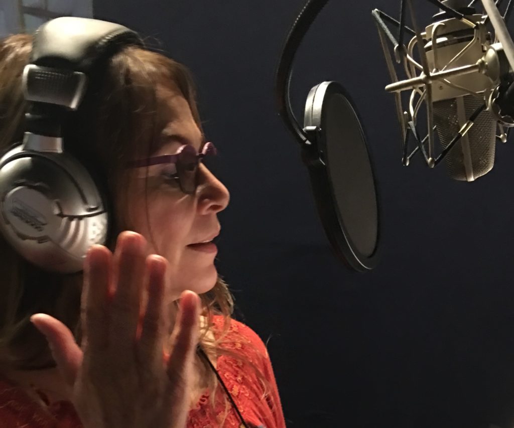 Phebe Phillips reading an audio book in a recording studio