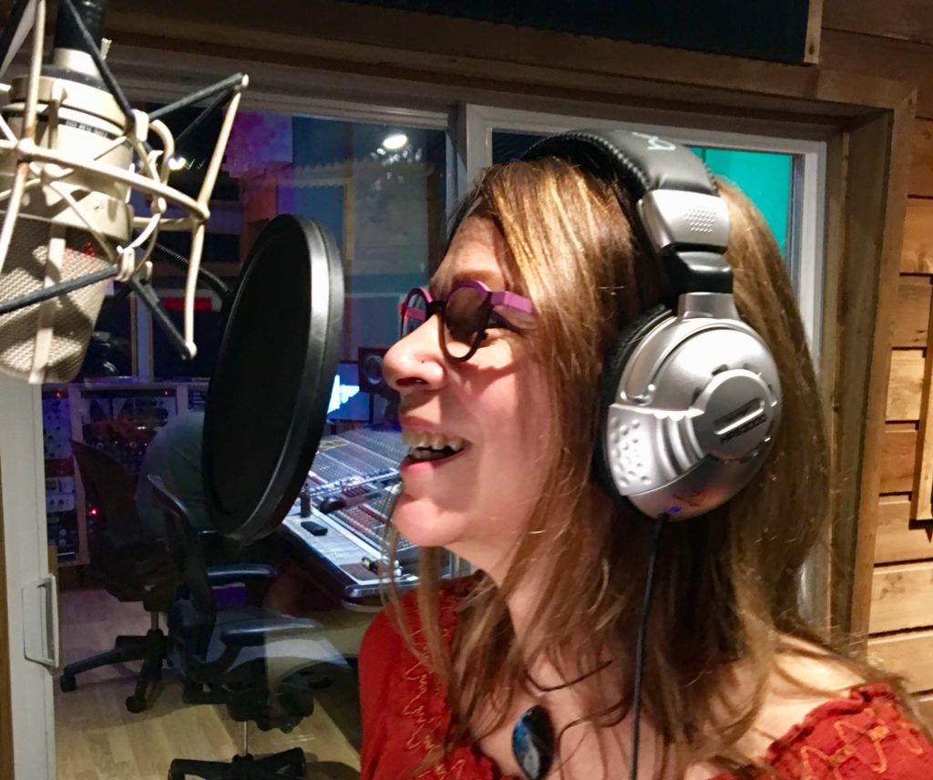Phebe Phillips recording an audio book in a recording studio